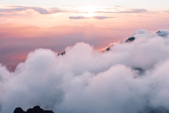 Wokenmeer über den Bergen mit Sonnuntergang