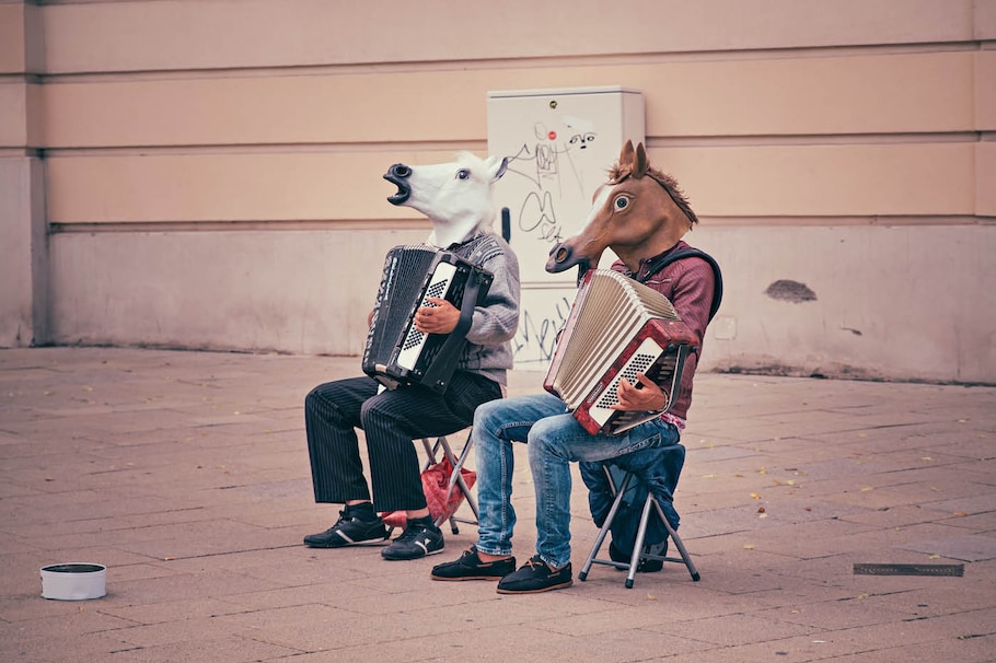 Harmonikaspieler auf der Straße mit einer Pfermaske