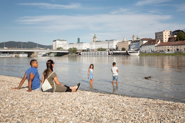 Familie sitzt am Flussufer