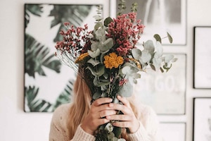 Frau mit getrocknetem Blumenstrauß